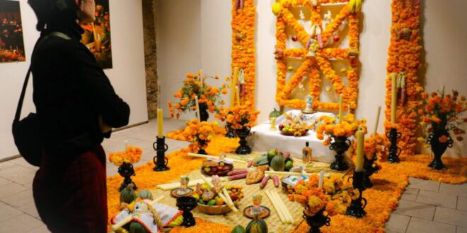 Altar de muertos de Michoacán en el Museo Pedro Coronel, decorado con flores y velas, representa la tradición de la ribera del lago de Pátzcuaro.